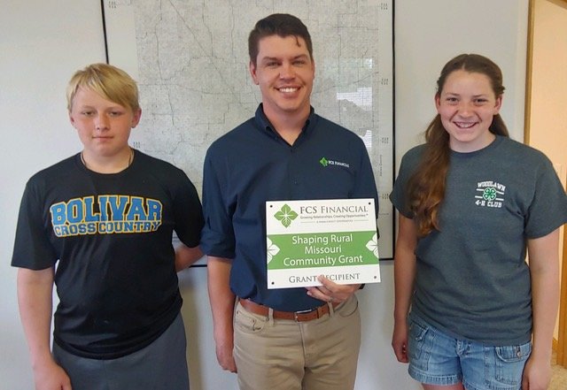 Accepting the grant on behalf of the Woodlawn 4-H Club is Garret and Ellie Samek.