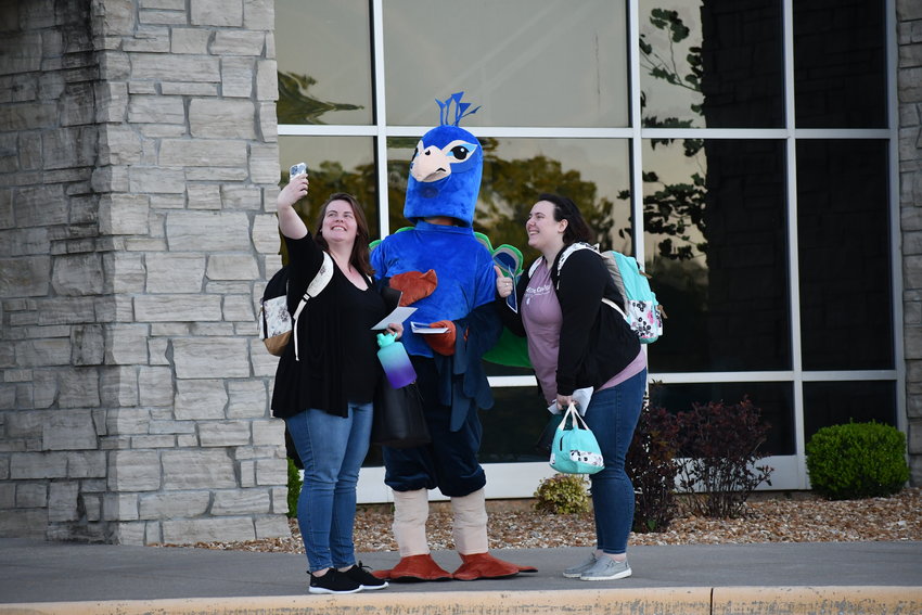 BTC Admissions Representative, Daniel Leith, poses for a selfie in a peacock costume with RN students, Shawnee DeBoeuf and Cheyanne Deboeuf.