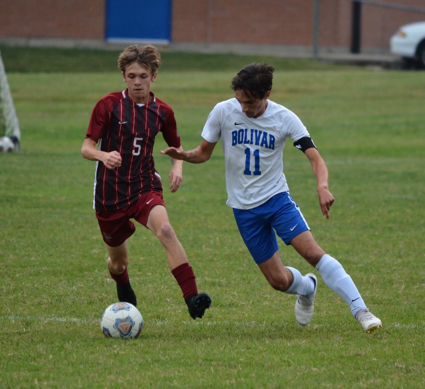Trying to win the ball back for Bolivar, senior Colton Rowe looks for an opportunity to steal.
