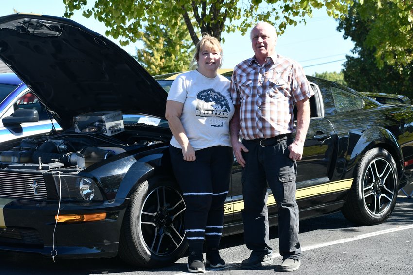Kim Stanek and David Jump pose with David&rsquo;s 2006 Ford Mustang Shelby GT.