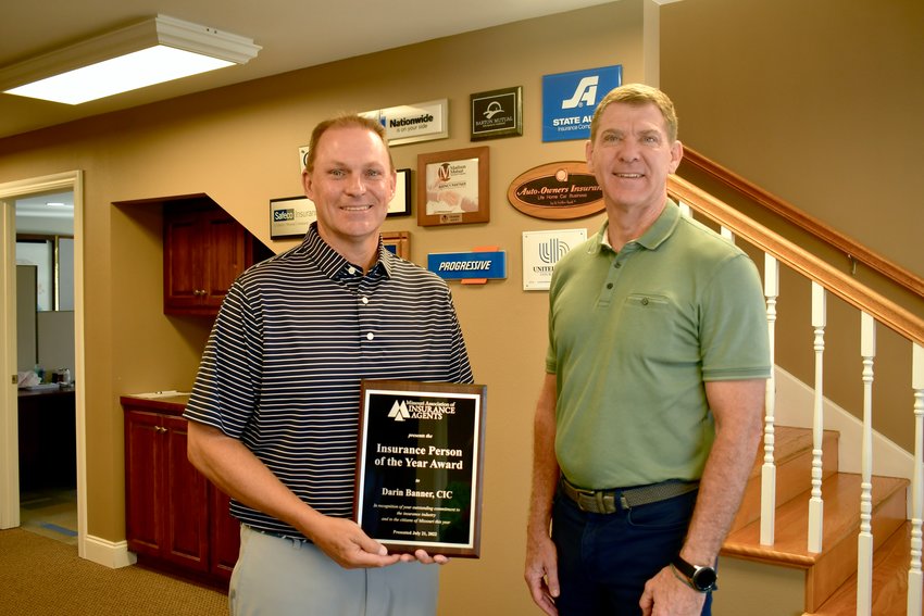 Darin Banner with his award and Kevin Kruger, Principal/Owner Capstone Insurors.