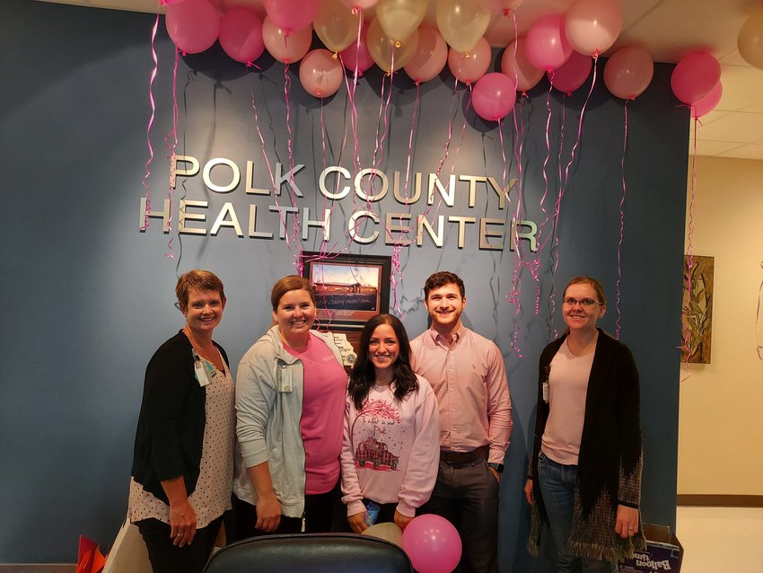 Celebrating Pink Out Day, Polk County Health Center raises awareness for breast cancer by decorating with balloons and passing out pink ribbon cookies on Wednesday, Oct. 12. Pictured left to right: Michelle Morris, Tiffany Corum, Aleisha Wise, Nick Lantz, and Noelle Kates.