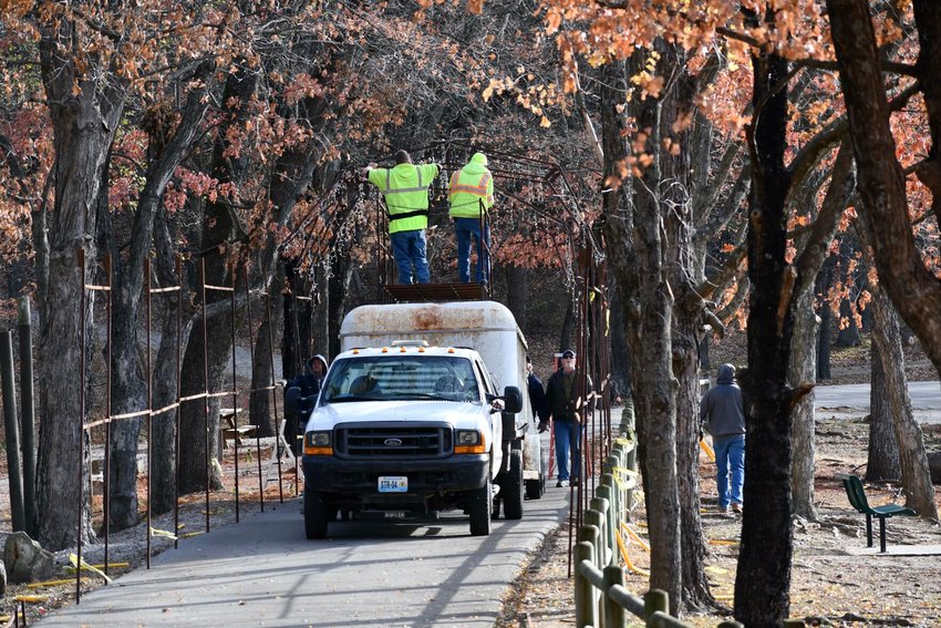 Monday morning turned out to be a chilly but pleasant day for the crews from the city and Liberty to start bringing Christmas to Dunnegan Memorial Park in Bolivar.   STAFF PHOTO/LINDA SIMMONS