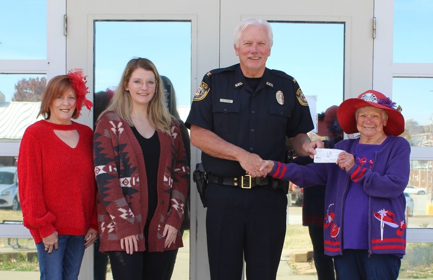 Connie Doke, far left, and Bev Swihart, far right, with Bolivar&rsquo;s Red Hat Society donate $200 to the Bolivar Police Department&rsquo;s program coordinator Margaret Baker and chief Mark Webb, center, for this year&rsquo;s Shop with a Cop event.