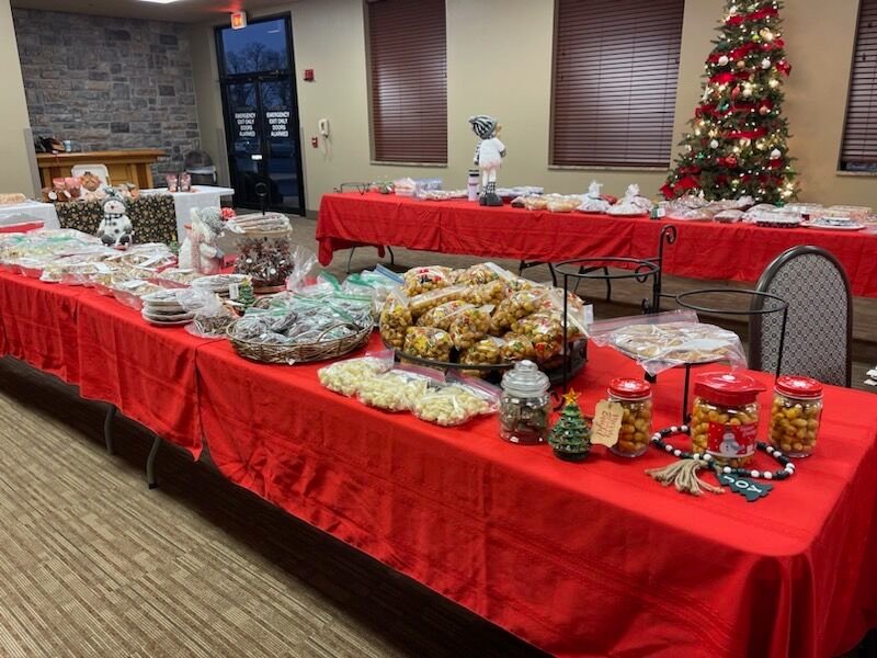 Giving a cozy atmosphere, CMH Community Room is set up for the bake sale as tables are fully stocked with a variety of homemade goods.