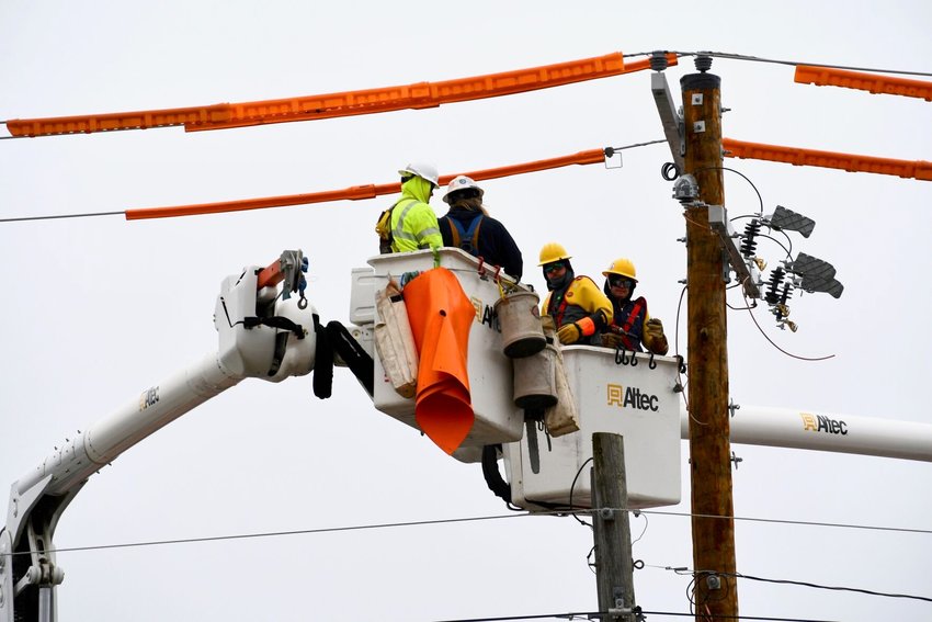 There wasn&rsquo;t much of a warm up during the day Monday, Dec. 19, for the crews that worked through the day replacing the pole on South Springfield Ave.   STAFF PHOTO/LINDA SIMMONS