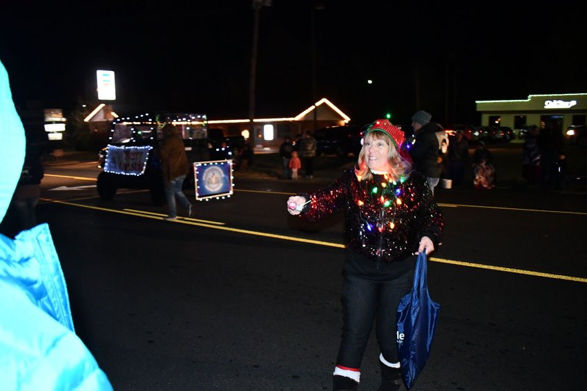 Even the cold night air didn&rsquo;t keep Carol Poindexter, Polk County recorder, from walking in the Bolivar Christmas parade and handing out candy and warm smiles for everyone.   STAFF PHOTO/LINDA SIMMONS
