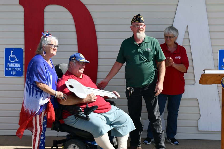 Handing the key off to USAF Veteran Alan Heard, with his wife Nancy Heard by his side, is Commander Michael Carr as Auxiliary Commander Human watches on.   STAFF PHOTO/LINDA SIMMONS