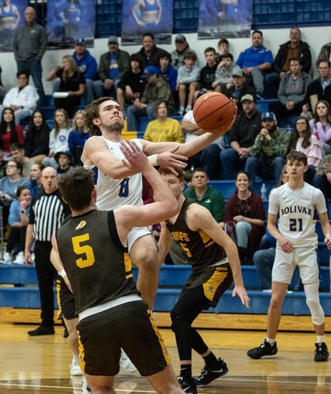 Liberator Jack Larimore splits two Chiefs for a driving shot.   STAFF PHOTO/BOB CAMPBELL