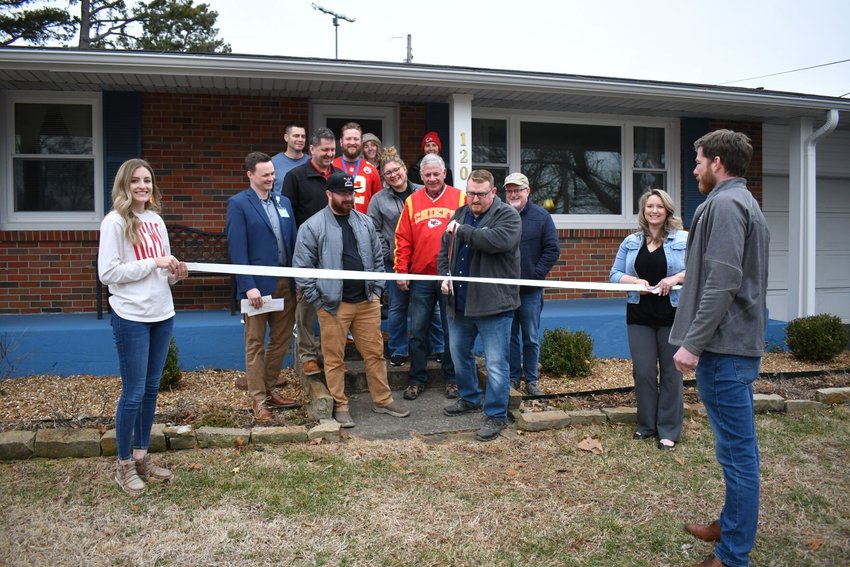 Members of the Bolivar Area Chamber of Commerce gather with the leaders of Restore 12:12 Ministries for a ribbon cutting ceremony at the R&amp;amp;R House, the ministry's transitional housing program for young adults.