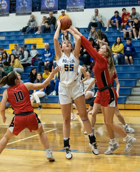 Senior Lady Liberator #55 going for a basket, deterred by a Zizzer.   STAFF PHOTO/BOB CAMPBELL
