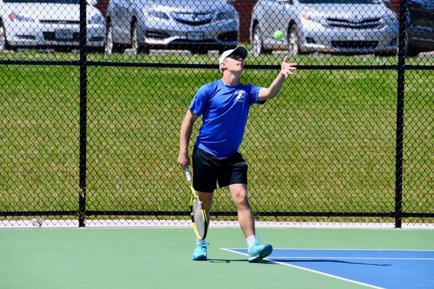 Seth Martin prepares to serve during a doubles match at the Bolivar Invitational Tournament on Monday, April 17.   STAFF PHOTO/LINDA SIMMONS