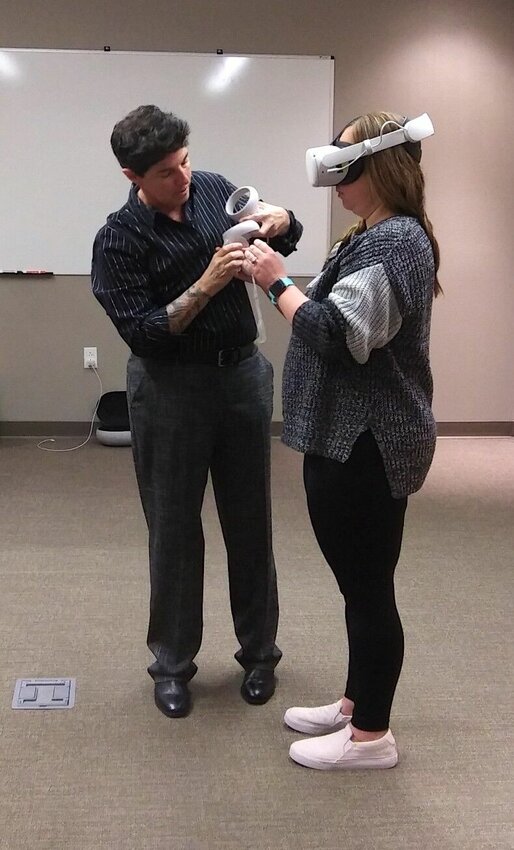 Pictured is the Elsevier representative training BTC Instructor and Practical Nursing Program Coordinator, Courtney Sulltrop, how to use the VR equipment in a simulation.