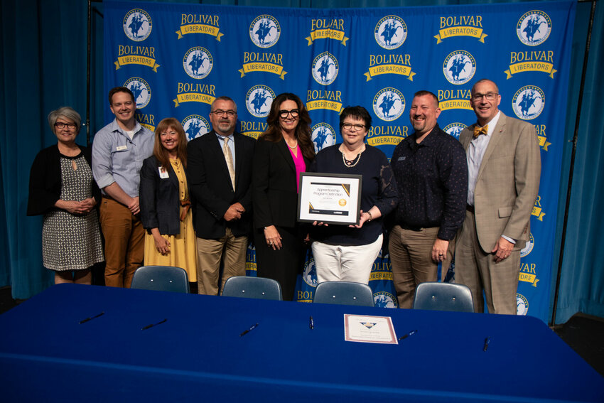 Displaying the program distinction, Betty Glasgow accepts the award on behalf of the BoMO Works Apprenticeship program.