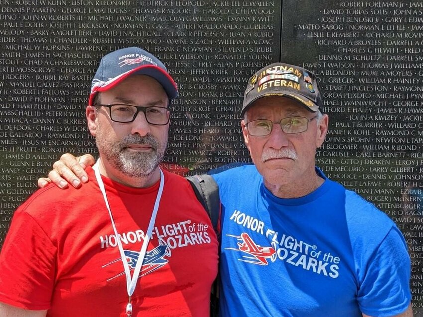 Dan Woollard, along with his son, Shane, stop at the Vietnam Veterans Memorial in Washington D.C. during his Honor Flight trip to look for the names of Dan&rsquo;s buddies and the names of the 21 men in his unit who had been killed during the war.