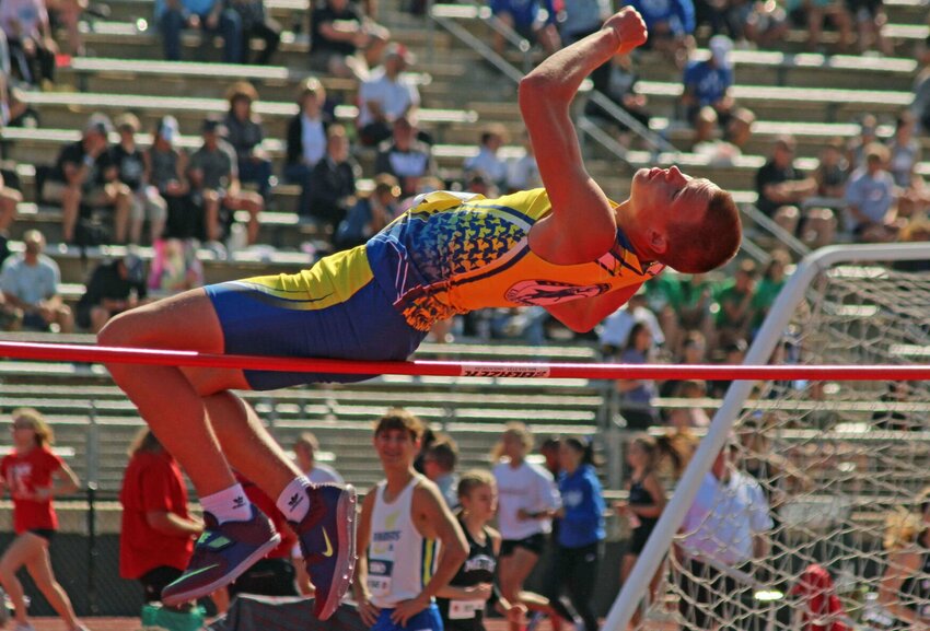 Jason Wilkinson maneuvers over the bar during the high jump event.