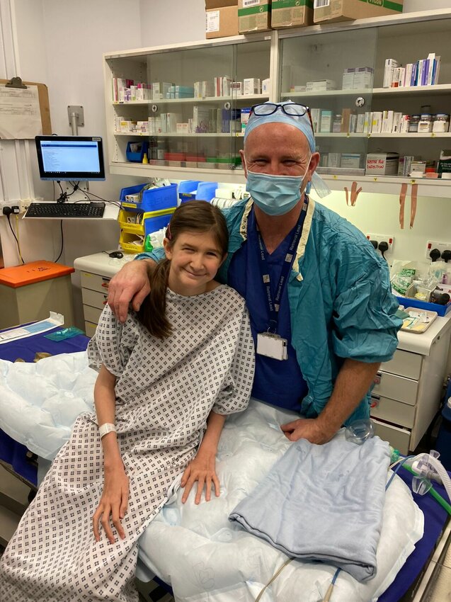 Nine-year-old Moxie Garrison of Bolivar consults with her doctor about her heart surgery.