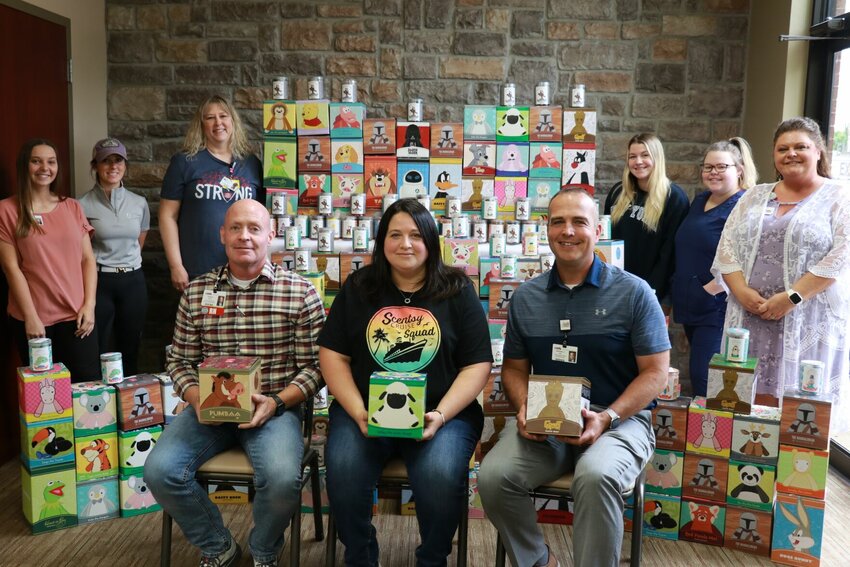 Front row: Chad Garner, RN, director of hospital nursing operations (left) and Michael Calhoun, CEO/executive director of CMH and CMH Foundation (right) accepted donations from Megan Romesburg (center) and her Scentsy team. The Scentsy group donated more than 300 stuffed Scentsy Buddies for pediatric patients in the CMH Emergency Department. Back row, left to right: Cheyanne Matlock, Heather White, Terri Park, Lakyn Breesawitz, Taylor Breesawitz, Amanda Burton. Not pictured are Sara Gary and Stacie McNew.