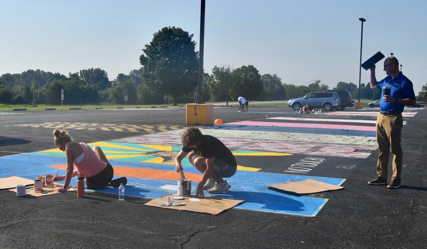 Even with the morning temperature close to 90 before 9 a.m., students at Bolivar High School didn't let that stop them from getting their parking spaces ready for the new year.   STAFF PHOTO/LINDA SIMMONS