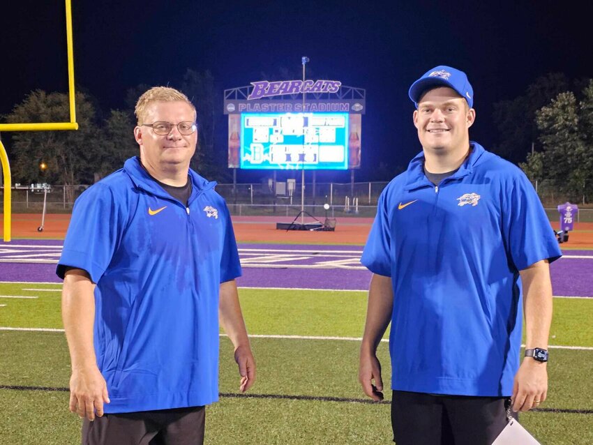 Liberator head coach, Eric LaSalle and defensive coordinator, Jacob LaSalle, father and son coaching team, stand in front of the scoreboard after the Liberators won their first game of the season.   CONTRIBUTED PHOTO/JENNIFER CARR