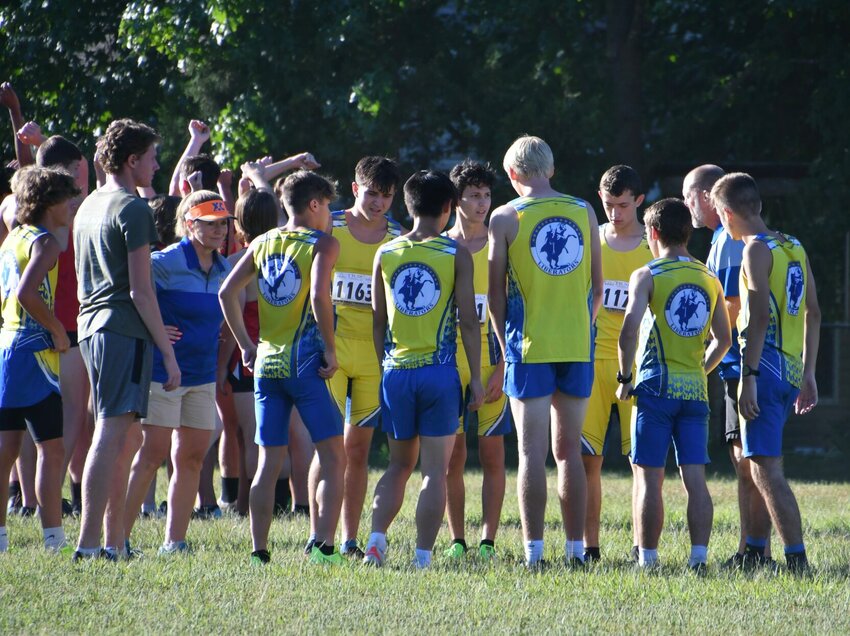 The varsity boys team get a pre-run pep from the coaches.   STAFF PHOTO/LINDA SIMMONS