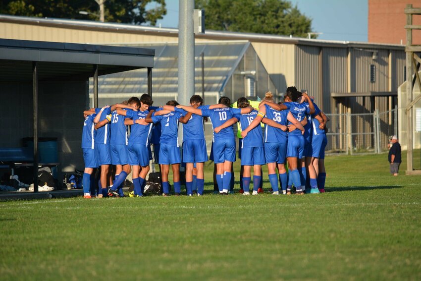 Liberators prepare for their match with a team prayer.   STAFF PHOTO/CAMERON HOLCOMB