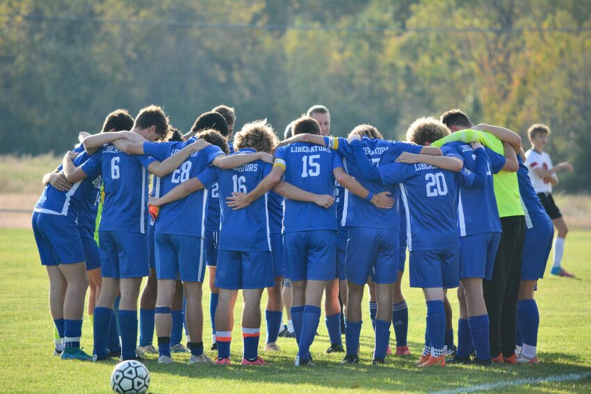The Liberator soccer team gathers for a pre-game prayer before the game on Thursday, Oct. 26.   STAFF PHOTO/CAMERON HOLCOMB