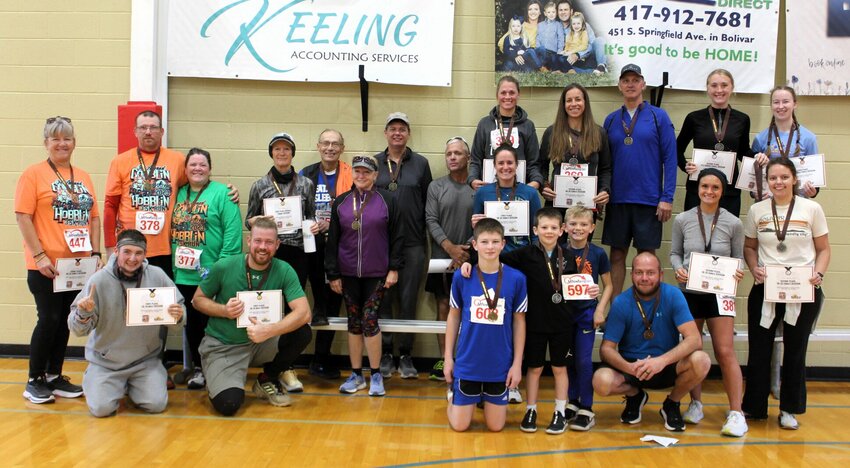 The medalists for each division of the 5K race pose for a photo at the Bolivar Recreation &amp;amp; Aquatic Center after receiving their medals.   CONTRIBUTED PHOTO