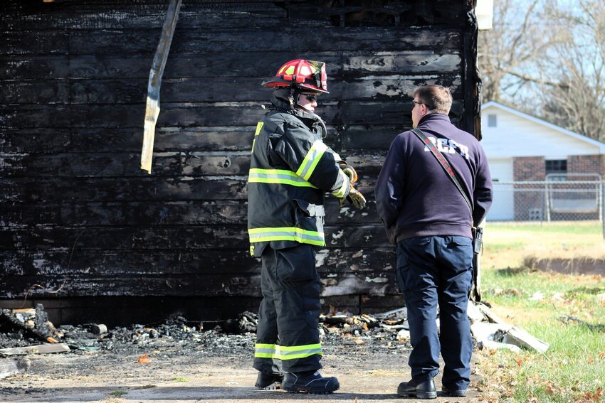 Captain Scott Jones and Chief Brent Watkins examine the damage to a home involved in a residential structure fire in the early morning hours of Wednesday, Nov. 22.   CONTRIBUTED PHOTO