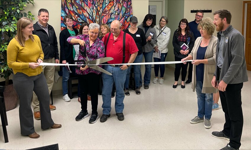 Roxy and Kevin Hudson cut the ribbon surrounded by chamber members as well as friends and family.   CONTRIUBTED PHOTO