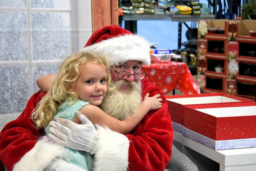 Santa and a shopper share a hug after her shopping trip.   CONTRIBUTED PHOTO
