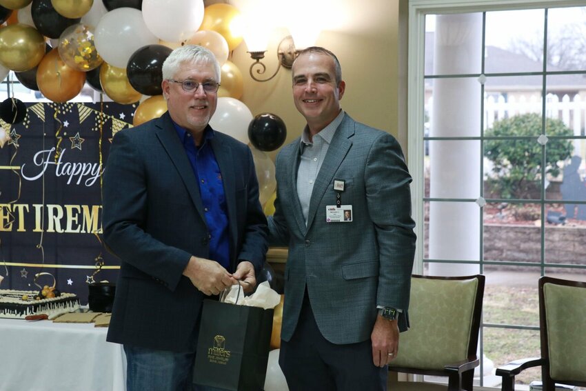Chris Vickers (left) receives a retirement gift from Mike Calhoun, CEO/Executive Director of Citizens Memorial Hospital/Citizens Memorial Health Care Foundation, during Chris&rsquo;s retirement reception at Community Springs Healthcare Facility on Friday, Jan. 5.   CONTRIUBTED PHOTO