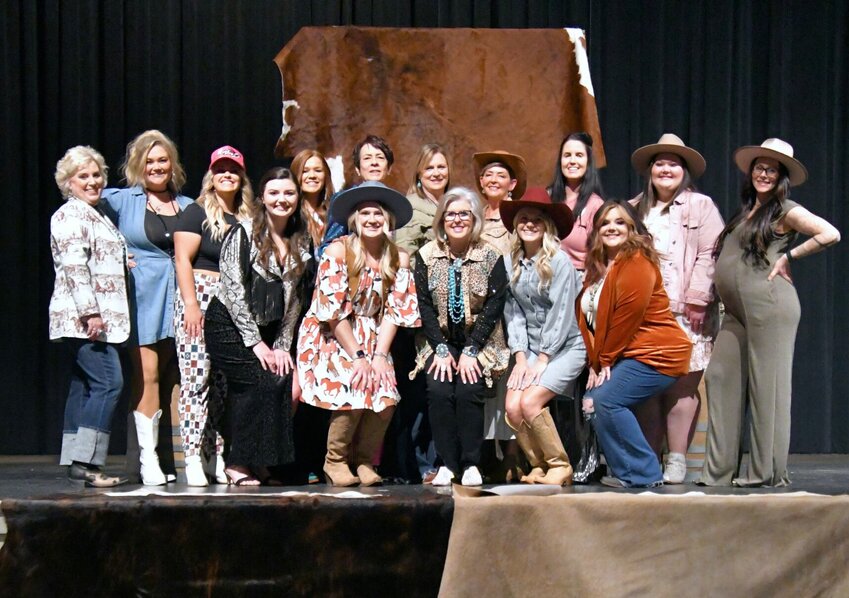 Missouri Beef Days Fashion Show vendors pose with emcee Susy Crites and committee chairs, Taylor Hillenburg and Lisa Lehman of Craig Lehman Shelter Insurance, fashion show sponsor.   STAFF PHOTO/LINDA SIMMONS