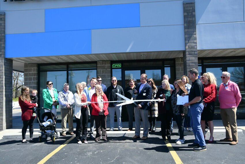Michael Calhoun, CEO of Citizens Memorial Health Care Foundation, proudly cuts the ribbon surrounded by CMH employees, chamber members and friends and family.   STAFF PHOTO/LINDA SIMMONS