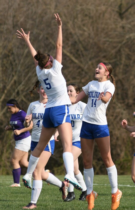 The Garber sisters, Ellen (#5) and Sophia (#14), celebrate Sophia&rsquo;s first varsity goal that followed a free kick from Ellen in the game at Fair Grove.   STAFF PHOTO/ANNIE THOMAS