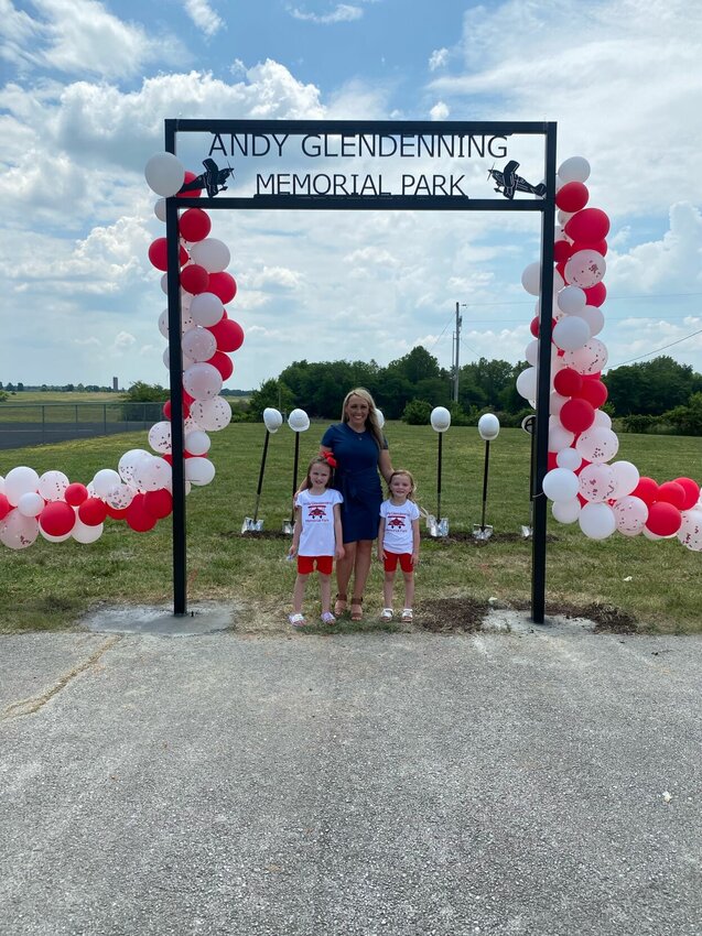 Abby Glendenning and daughters Ellie and Mila stand at the entrance of the park that will be named for their late husband and father, Andy Glendenning, at the park&rsquo;s groundbreaking event June 2, 2023.   CONTRIUBTED PHOTO