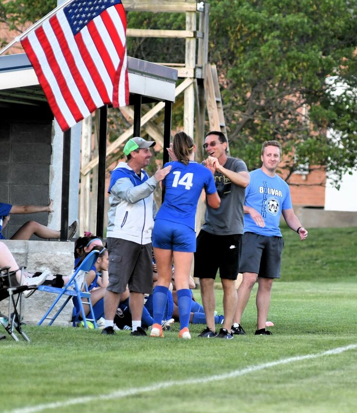 Coaches Steve Fast, Jeff Edge, and Jacob Allee congratulate Sophia Garber as she takes a break after picking up a goal.   STAFF PHOTOS/ANNIE THOMAS