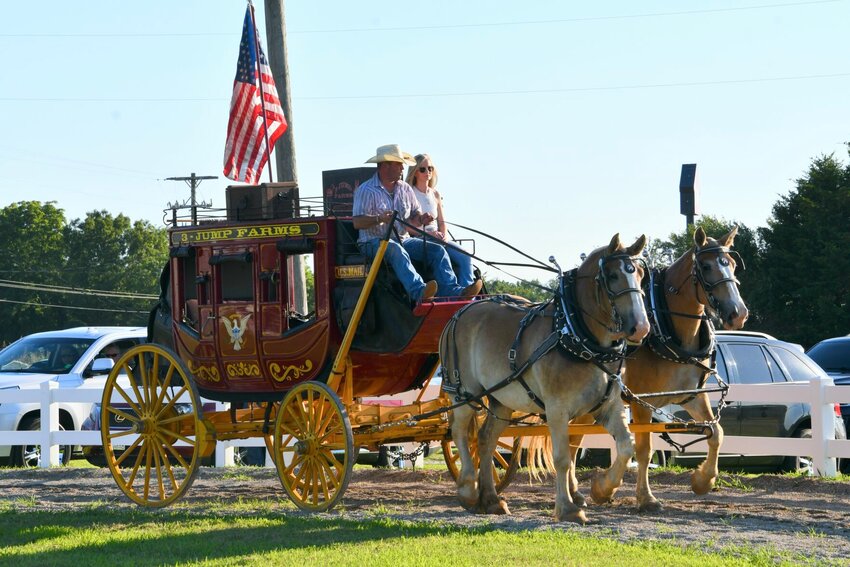 John Hale and Trish Berry delivered the judges to the arena in the 3-Jump Farms stagecoach, drawn by 3-year-old Molly and Maggie.   STAFF PHOTO/LINDA SIMMONS