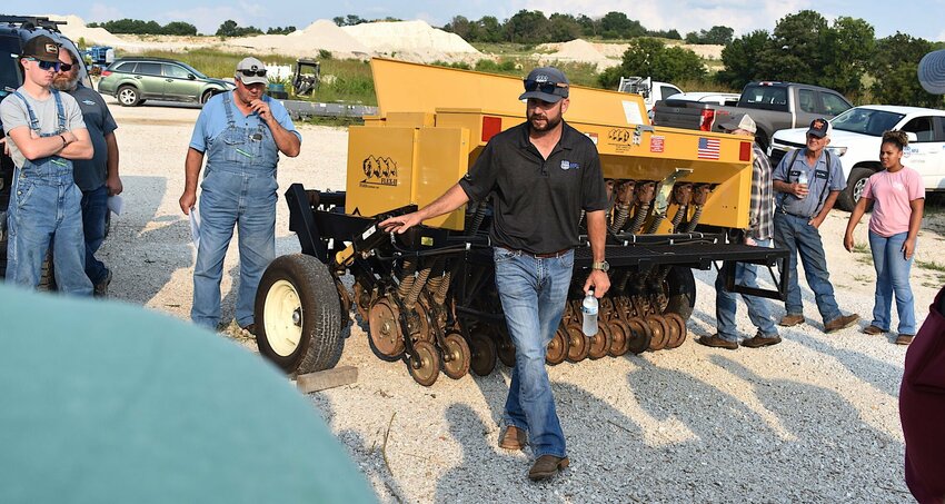 Landry Jones, conservation grazing specialist with MFA, Inc., introduced participants in the warm season native pasture walk to the features of a drill designed specifically for NWSG seeding.   STAFF PHOTOS/JIM HAMILTON