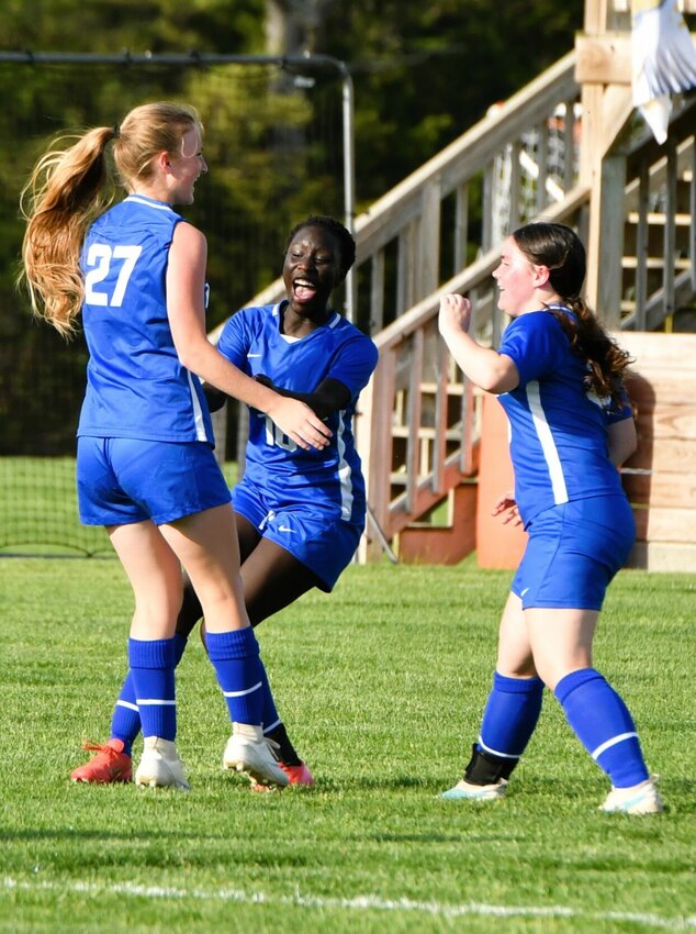 Zoe Tull, number 27, celebrates with teammates Olivia Vernon, center, and Abby Clark after adding to the Lady Liberator lead with her goal against Aurora.


STAFF PHOTOS/ANNIE THOMAS