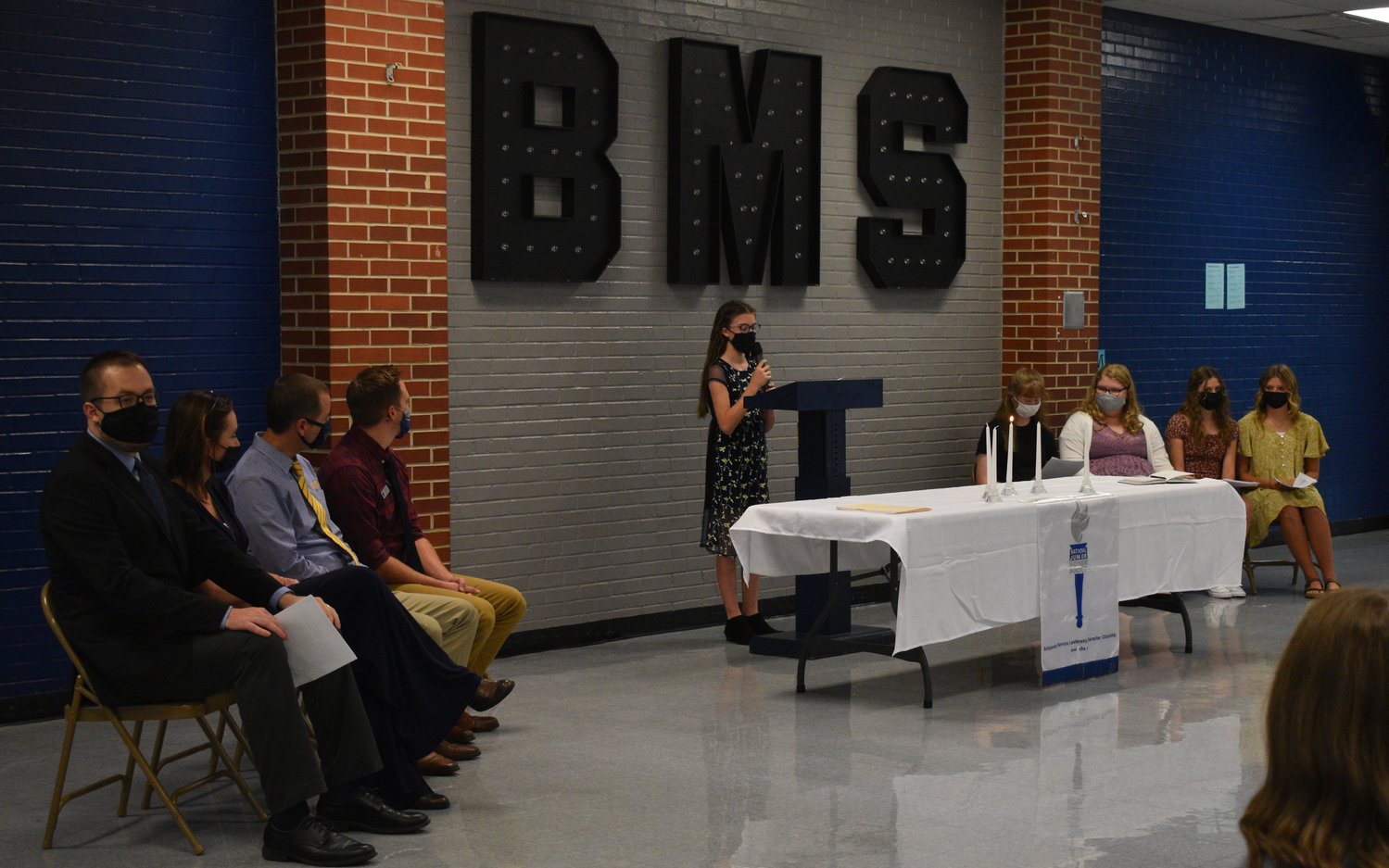 Bolivar Middle School NJHS chapter president Tessa Ludden welcomes the crowd of family and friends to the induction ceremony Monday, Oct. 18. Also pictured are, from left, advisers Dakota Twenter and Annette Fugitt, principal Tim Garber, assistant principal Benjamin Potter, vice-president Jaylee Bryant, secretary Chloe Way and members Rhyan Roberts and DeLaney Daniels.