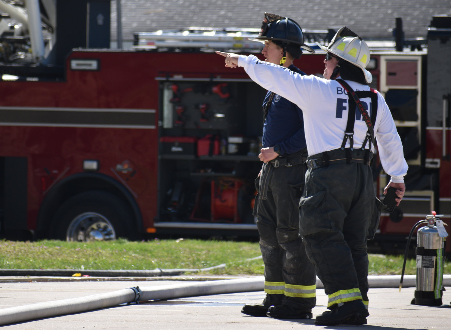 Bolivar City Fire Chief Brent Watkins points out something of interest to firefighter Caleb Dunaway during the controlled burn.