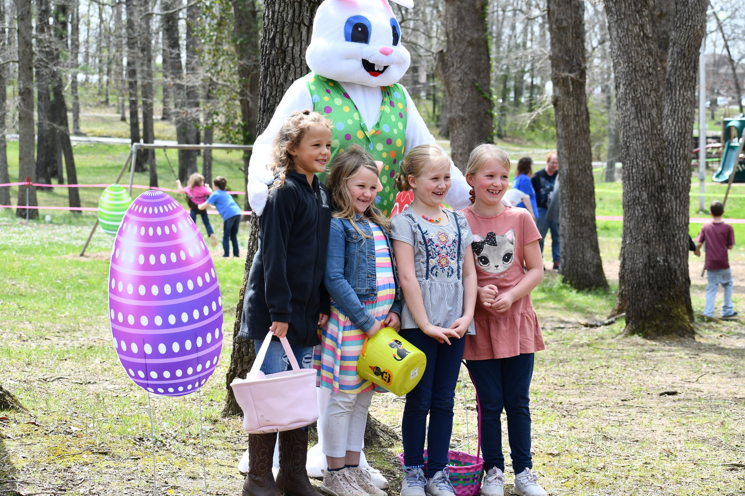 June Ward, Annallin Griswold, Leah Trantham and Lilly Trantham are excited to pose with the Easter Bunny.