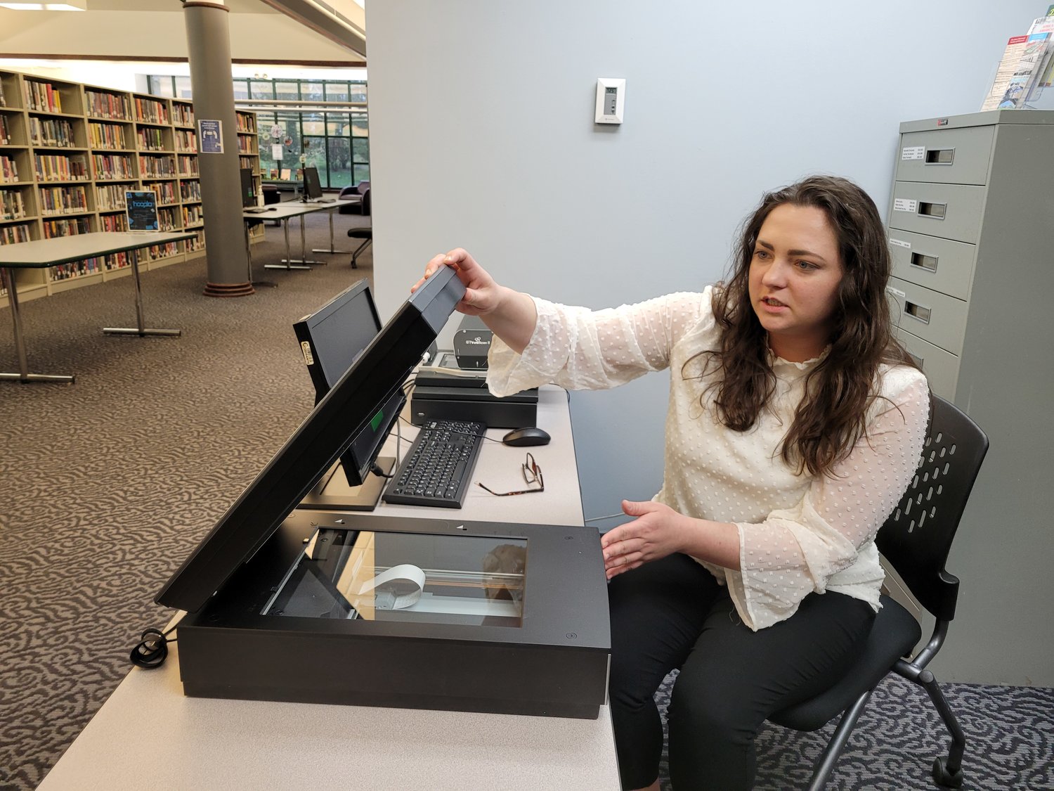 Tiffany Taylor, Polk County Library assistant director and grant writer, shows off the new photo scanner.