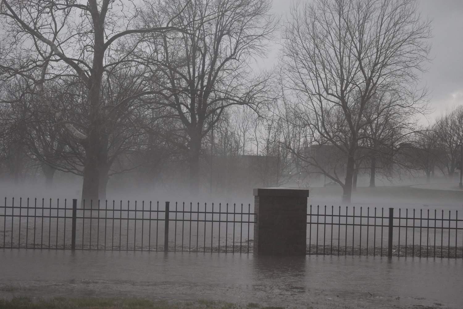 Fog rises from the flood waters filling the southeast corner of Southwest Baptist University’s campus.