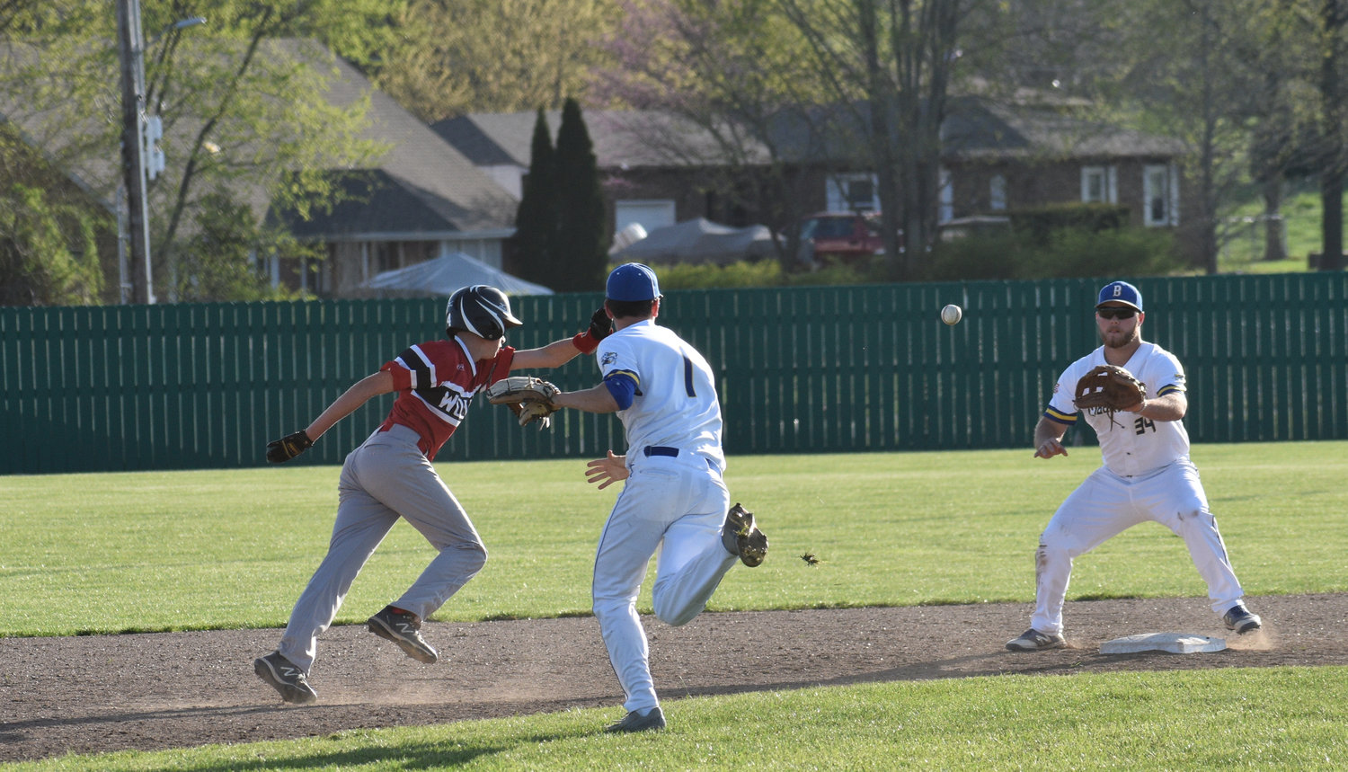 Shortstop Deacon Sharp catches a Reeds Spring player overrunning second base and throws to second baseman EJ Ingram for the out.