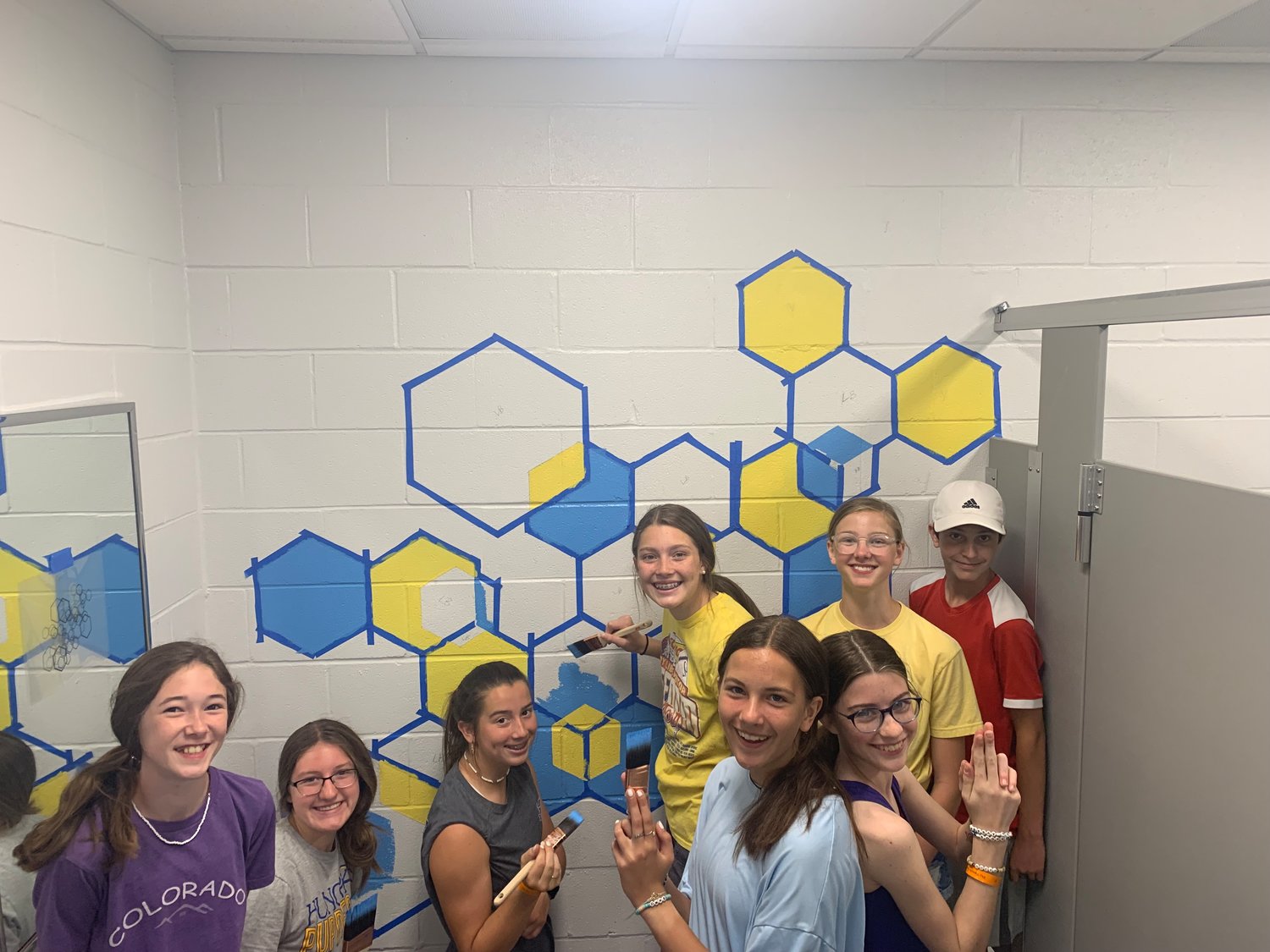 Bolivar Middle School NJHS members work on a bathroom beautification project. 