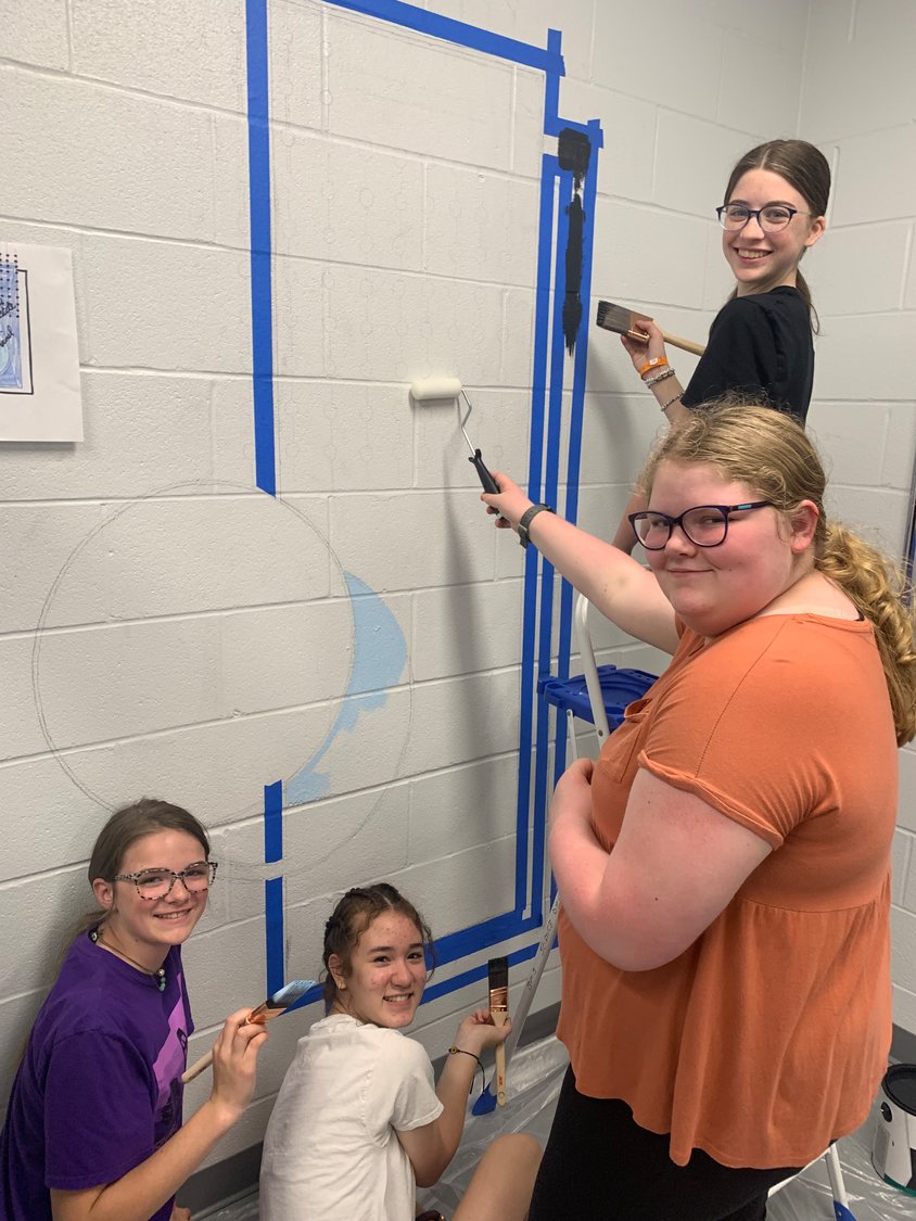 Bolivar Middle School NJHS members work on a bathroom beautification project. 