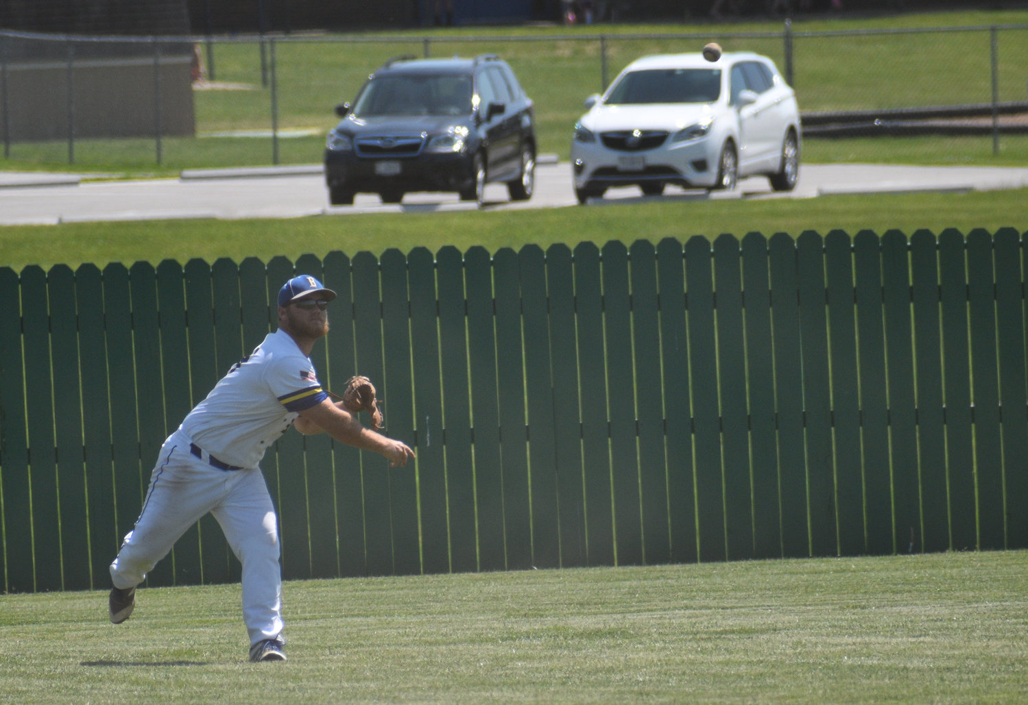 Junior Jake Banner throws a ball to the infield from centerfield.