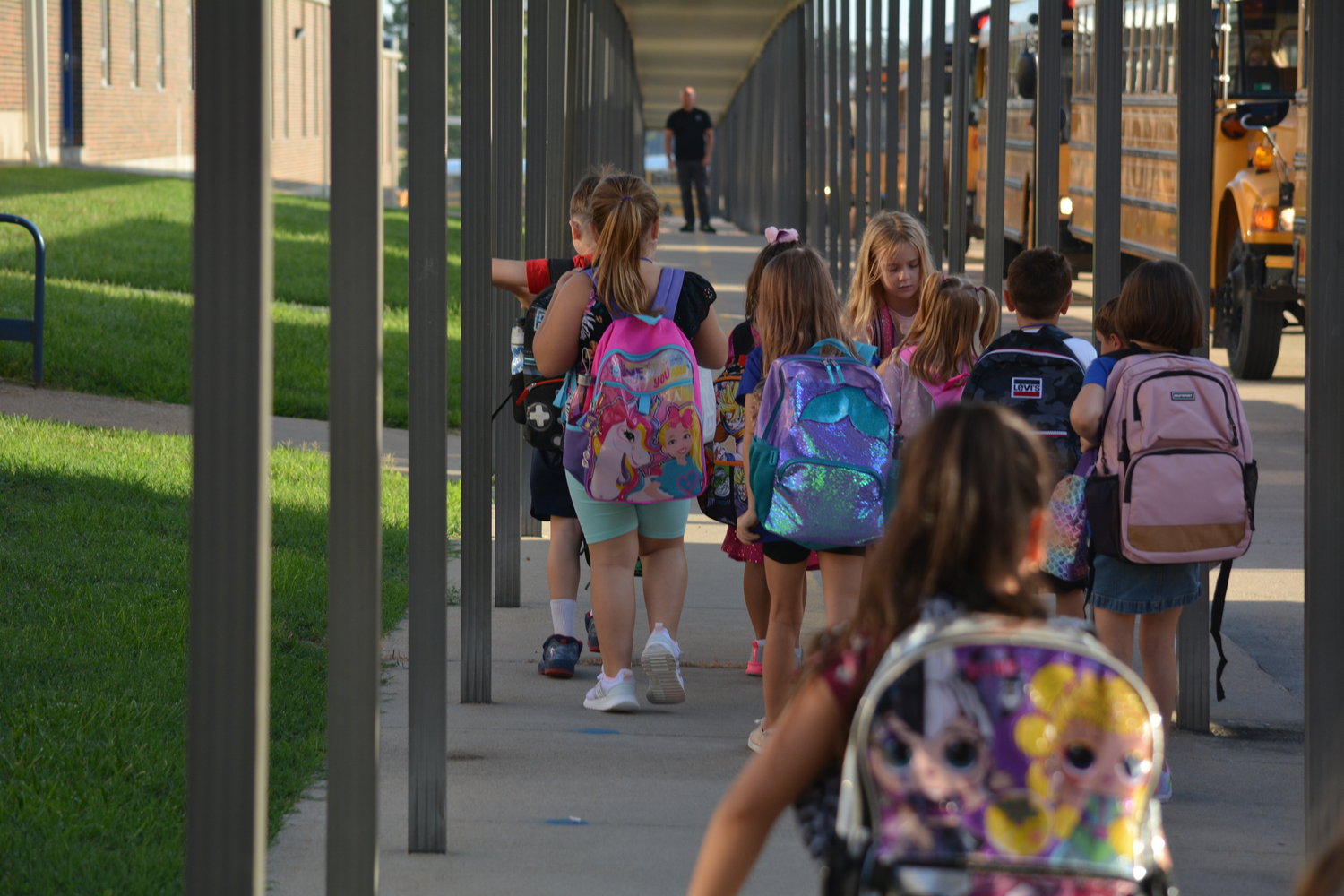 Students at Bolivar Primary School waved good-bye to their parents and stepped out of school buses to start their first day of kindergarten, first, and second grades.